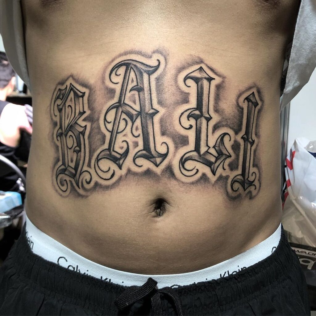 BALI tattoo lettering inked on stomach