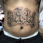 BALI tattoo lettering inked on stomach