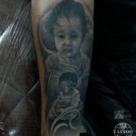 Realist portrait tattoo of child by Prima