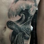 Black and grey ocean wave tattoo by Ukix