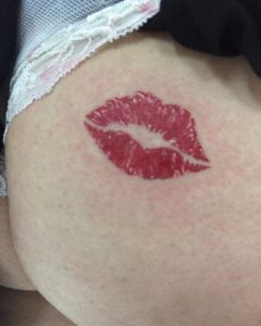 Lipstick mark butt cheek tattoo by Triblack Tattoo and Piercing