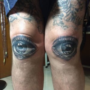 Kneecap tattoos of eyes by Manik Sumbang komingchaobigbrothers