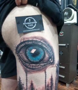 Kuta Inked Tattoo blue eye on thigh