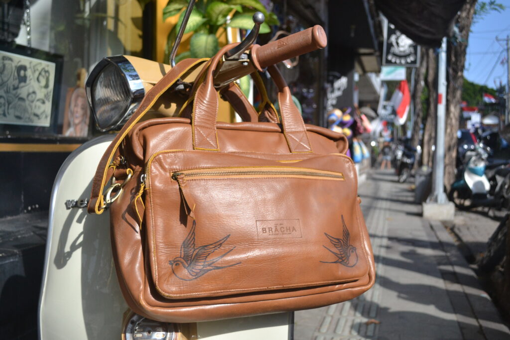 Swallow tattoos on Bali leather bag inked by Gunz for Tattlas