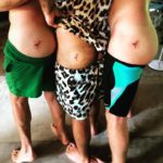 Three men bear butts to show off matching Bali tattoos from Bali