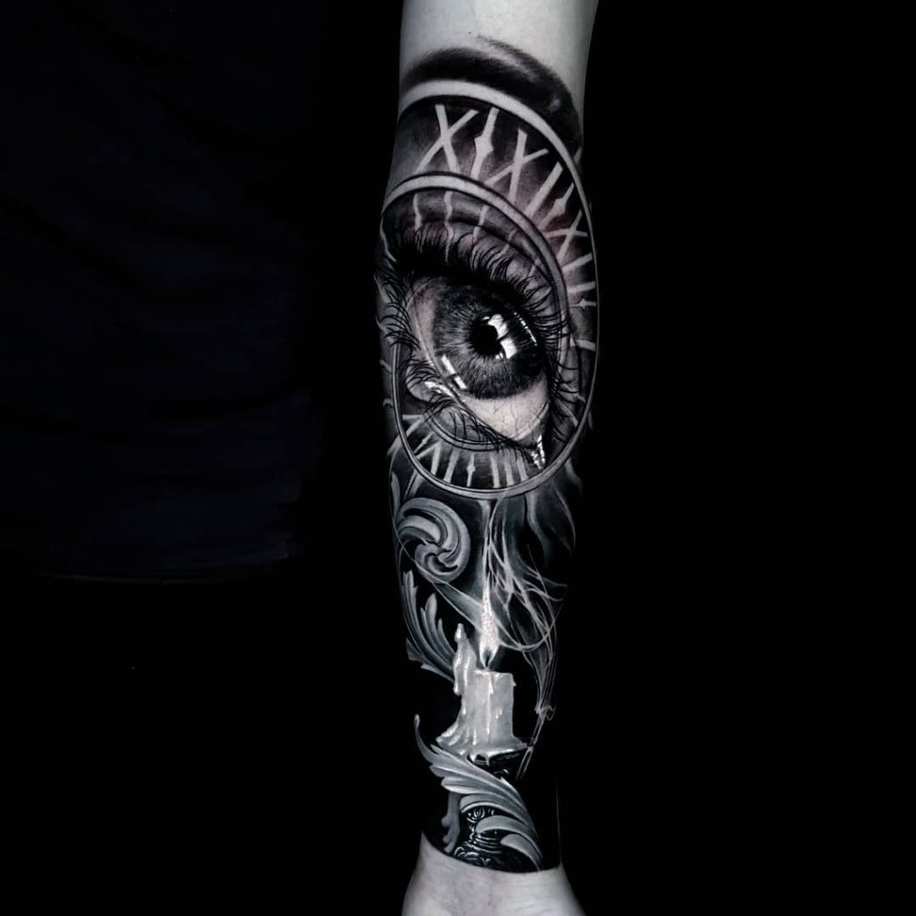 realistic eye tattoo in black and white sleeve by Ata Ink