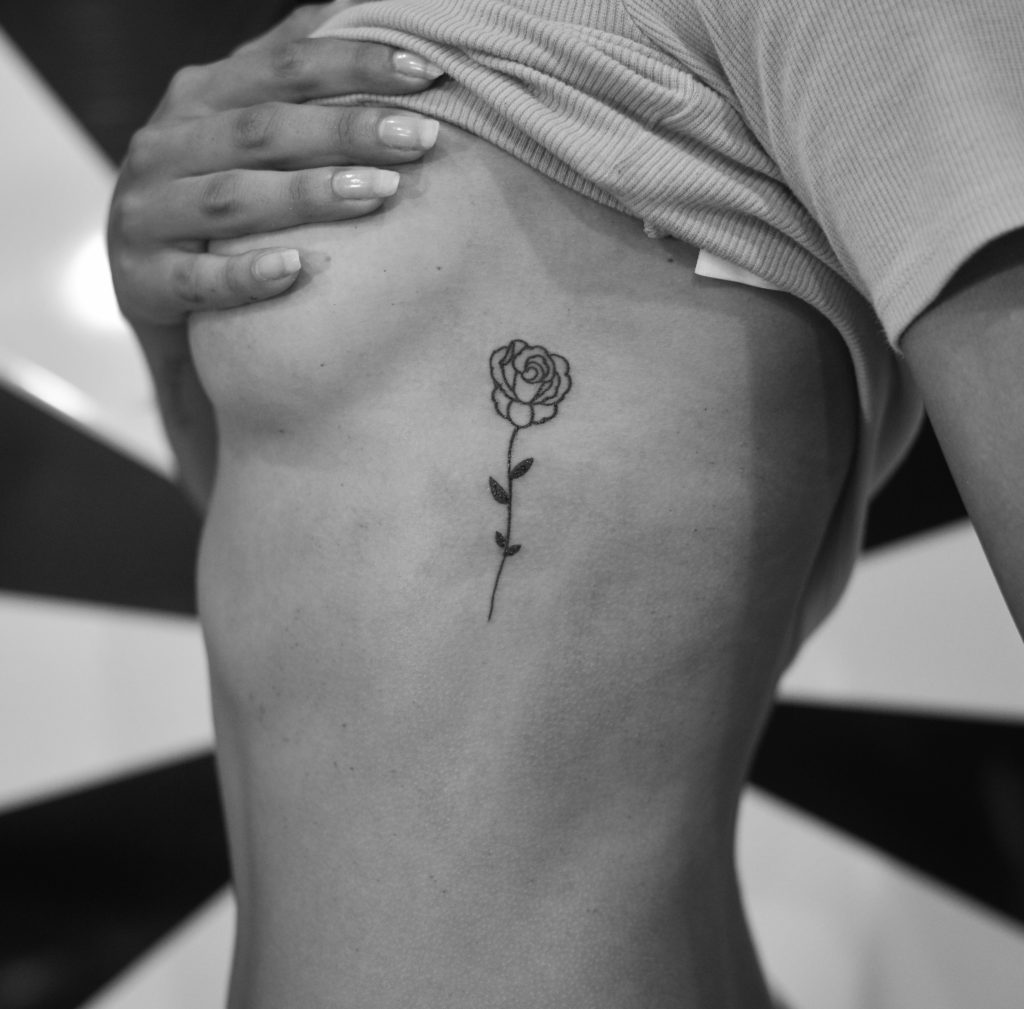 rose tattoo on womans side