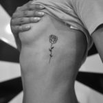 rose tattoo on womans side