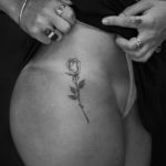 small rose tattoo on womans hip